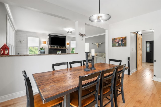 446 M And M Rd, Middletown, NY 10940 - dining space with a barn door, light wood finished floors, baseboards, and ornamental molding