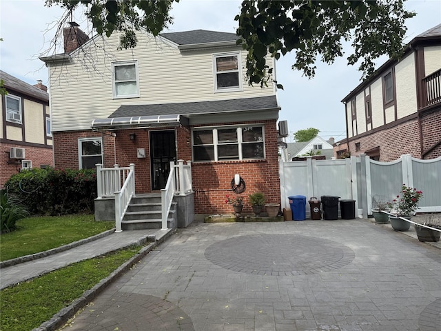 7308 187th St, Fresh Meadows, NY 11366 - view of front of home featuring a chimney, brick siding, and a patio area