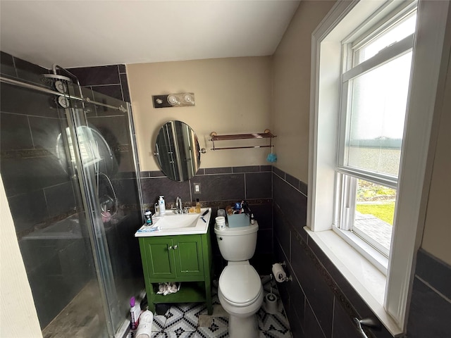 7308 187th St, Fresh Meadows, NY 11366 - bathroom featuring vanity, a stall shower, toilet, tile walls, and a wainscoted wall