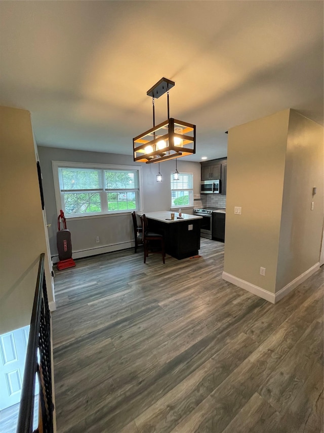 701 Towne House Vlg Unit 701, Hauppauge, NY 11749 - dining room featuring dark wood finished floors, plenty of natural light, a baseboard radiator, and baseboards