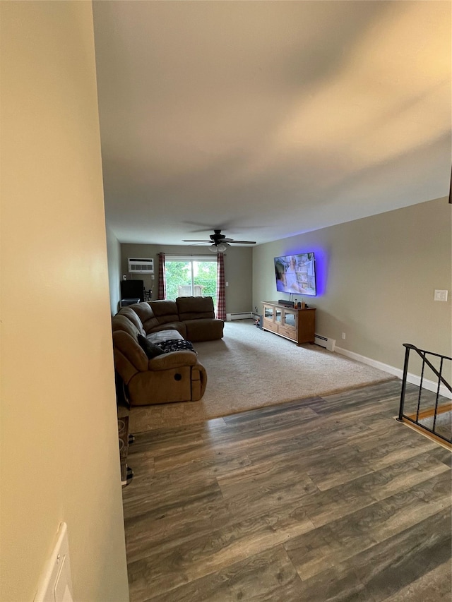 701 Towne House Vlg Unit 701, Hauppauge, NY 11749 - living area with baseboard heating, wood finished floors, a ceiling fan, and baseboards