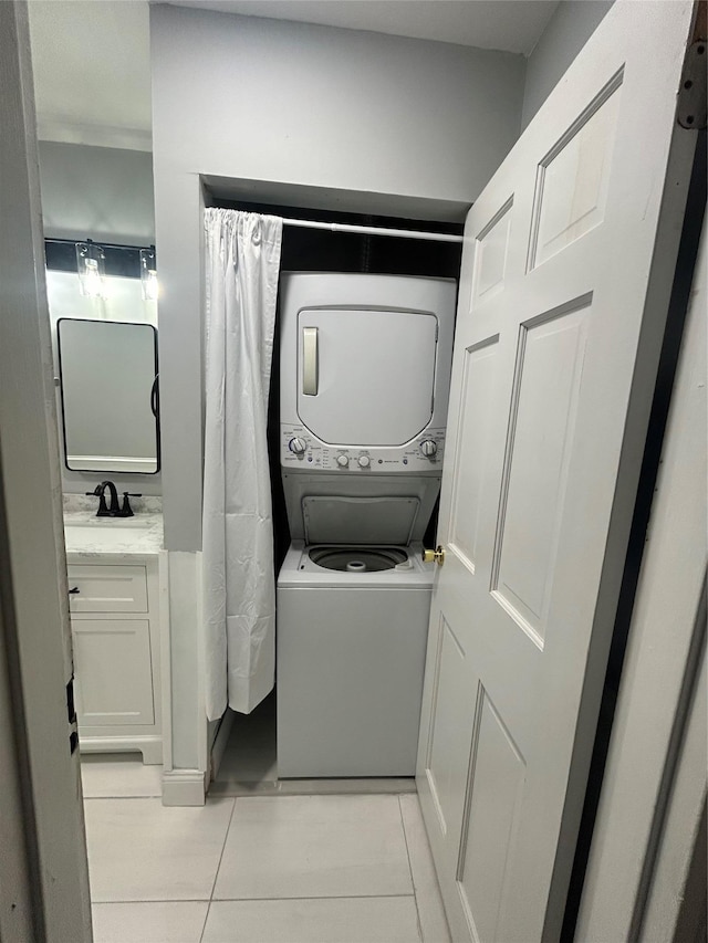 701 Towne House Vlg Unit 701, Hauppauge, NY 11749 - laundry area with stacked washer / dryer and light tile patterned flooring