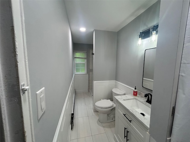 701 Towne House Vlg Unit 701, Hauppauge, NY 11749 - bathroom with toilet, tile patterned flooring, a shower, vanity, and a wainscoted wall