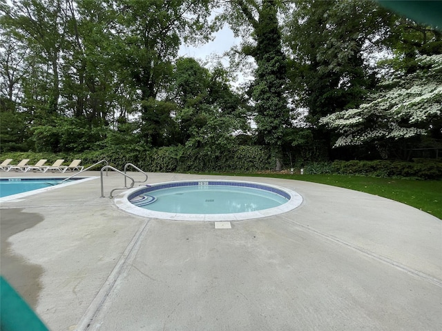 701 Towne House Vlg Unit 701, Hauppauge, NY 11749 - community pool featuring a patio area and view of scattered trees