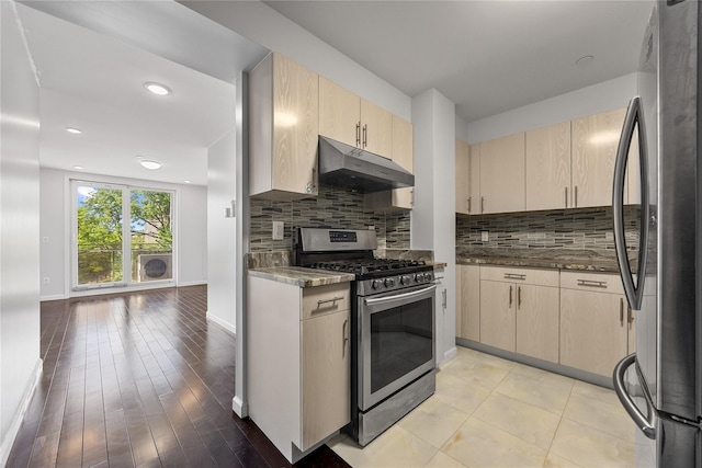 138-12 Northern Blvd Unit 3E, Flushing, NY 11354 - kitchen featuring appliances with stainless steel finishes, under cabinet range hood, light brown cabinetry, tasteful backsplash, and baseboards
