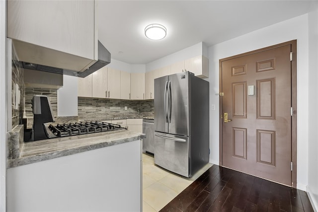 138-12 Northern Blvd Unit 3E, Flushing, NY 11354 - kitchen with appliances with stainless steel finishes, tasteful backsplash, baseboards, light stone counters, and light wood-type flooring