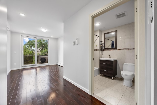 138-12 Northern Blvd Unit 3E, Flushing, NY 11354 - full bathroom with vanity, a baseboard radiator, toilet, wood finished floors, and baseboards