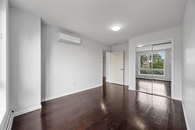 138-12 Northern Blvd Unit 3E, Flushing, NY 11354 - empty room featuring a baseboard heating unit, a wall unit AC, hardwood / wood-style flooring, and baseboards