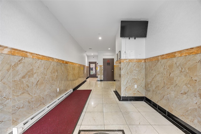 138-12 Northern Blvd Unit 3E, Flushing, NY 11354 - hallway with tile walls, recessed lighting, a baseboard radiator, wainscoting, and light tile patterned floors