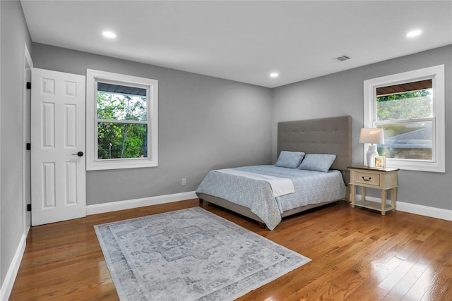 236 Martin Dr, Syosset, NY 11791 - bedroom featuring multiple windows, wood finished floors, baseboards, and recessed lighting