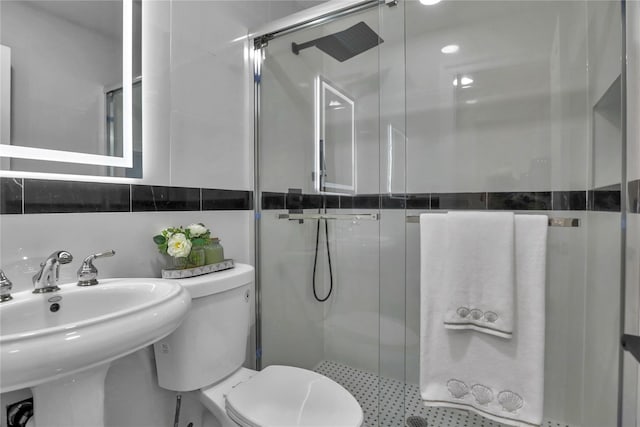 236 Martin Dr, Syosset, NY 11791 - bathroom featuring a stall shower, toilet, tile walls, and a sink