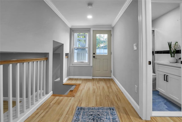 236 Martin Dr, Syosset, NY 11791 - entryway with ornamental molding, light wood finished floors, and baseboards
