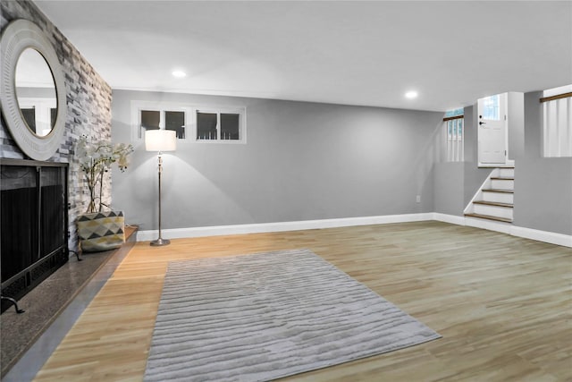 236 Martin Dr, Syosset, NY 11791 - unfurnished living room featuring baseboards, wood finished floors, stairs, recessed lighting, and a multi sided fireplace