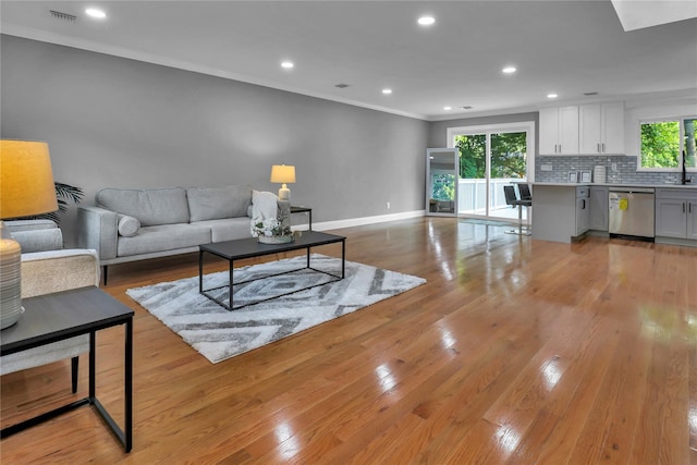 236 Martin Dr, Syosset, NY 11791 - living area featuring baseboards, light wood-style flooring, ornamental molding, and recessed lighting