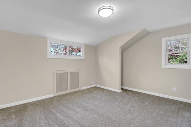 1459 Prince St, Baldwin, NY 11510 - bonus room with vaulted ceiling, carpet flooring, plenty of natural light, and baseboards