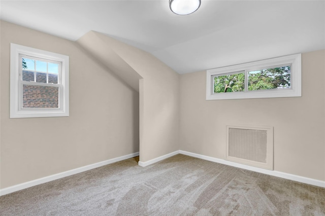 1459 Prince St, Baldwin, NY 11510 - additional living space with healthy amount of natural light, vaulted ceiling, carpet, and baseboards