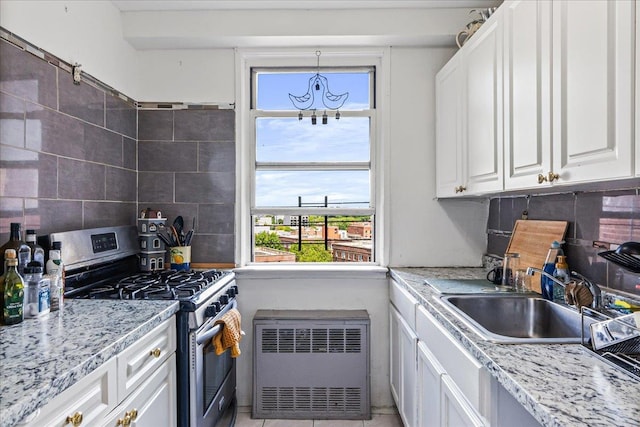 1655 Flatbush Ave Unit A1102, Brooklyn, NY 11210 - kitchen with stainless steel gas range oven, radiator, a sink, white cabinetry, and decorative backsplash