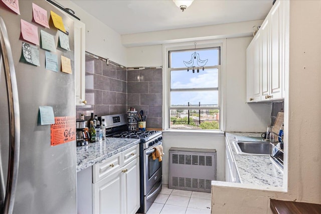 1655 Flatbush Ave Unit A1102, Brooklyn, NY 11210 - kitchen with appliances with stainless steel finishes, radiator, a sink, and white cabinetry