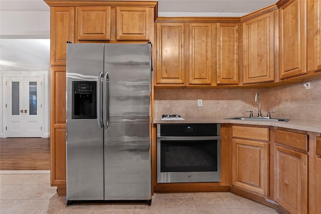 218 Middleton St Unit Apt6Rooftop, Brooklyn, NY 11206 - kitchen featuring stainless steel appliances, a sink, light tile patterned floors, light countertops, and brown cabinetry