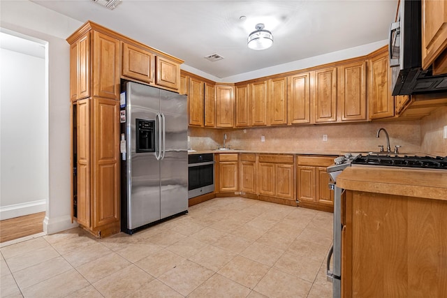 218 Middleton St Unit Apt6Rooftop, Brooklyn, NY 11206 - kitchen featuring stainless steel appliances, light tile patterned floors, decorative backsplash, a sink, and light countertops