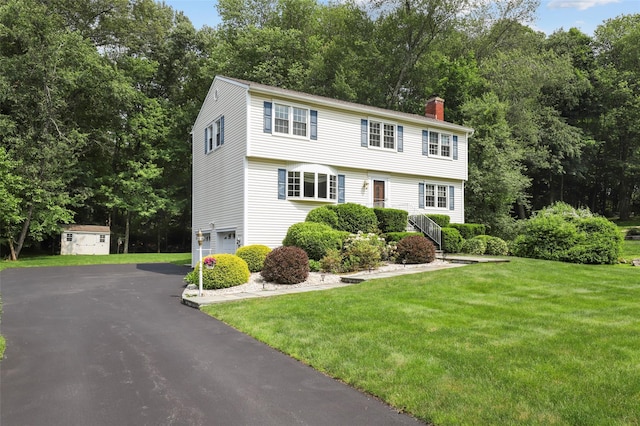 16 Shipley Dr, Cortlandt Manor, NY 10567 - colonial inspired home with a chimney, a garage, a front lawn, driveway, and a shed