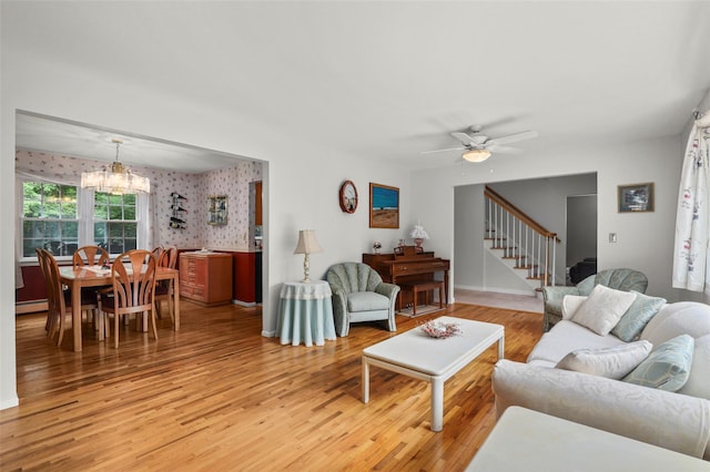 16 Shipley Dr, Cortlandt Manor, NY 10567 - living area with a chandelier, light wood-style flooring, a baseboard radiator, stairway, and wallpapered walls