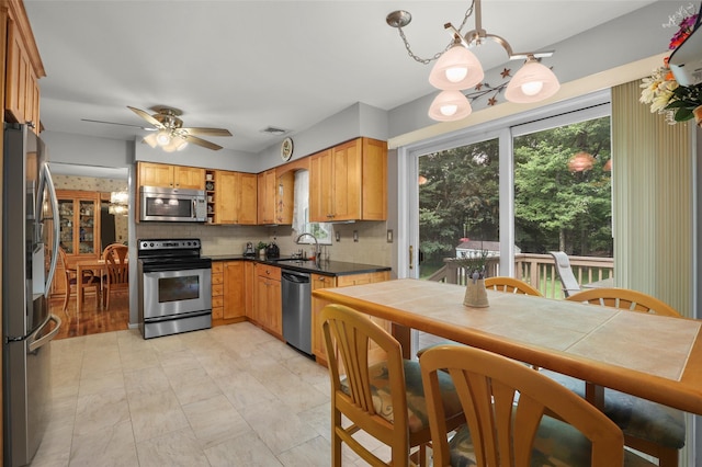 16 Shipley Dr, Cortlandt Manor, NY 10567 - kitchen with appliances with stainless steel finishes, a chandelier, and plenty of natural light