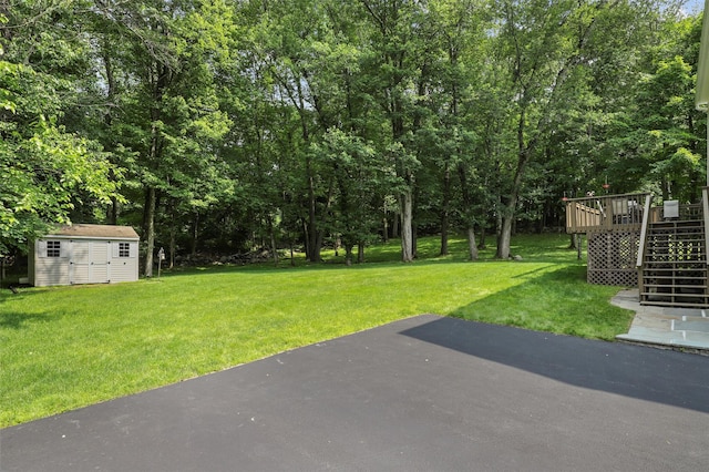 16 Shipley Dr, Cortlandt Manor, NY 10567 - view of green lawn featuring stairway, a patio area, a shed, and a wooden deck