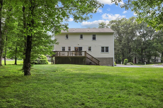 16 Shipley Dr, Cortlandt Manor, NY 10567 - rear view of property featuring stairway, a deck, and a lawn