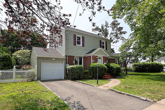 99 Roosevelt Ct, Carle Place, NY 11514 - colonial inspired home with an attached garage, driveway, and brick siding