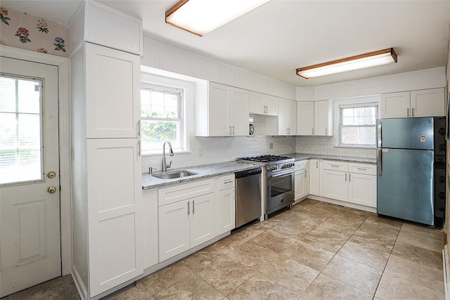 99 Roosevelt Ct, Carle Place, NY 11514 - kitchen featuring stainless steel appliances, a sink, plenty of natural light, and white cabinetry