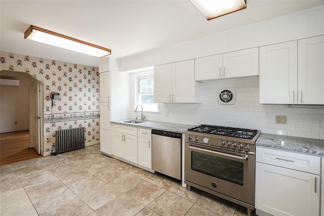 99 Roosevelt Ct, Carle Place, NY 11514 - kitchen with stainless steel appliances, radiator, an AC wall unit, wallpapered walls, and a sink