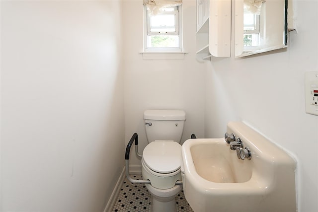 99 Roosevelt Ct, Carle Place, NY 11514 - half bathroom featuring toilet, a sink, and baseboards