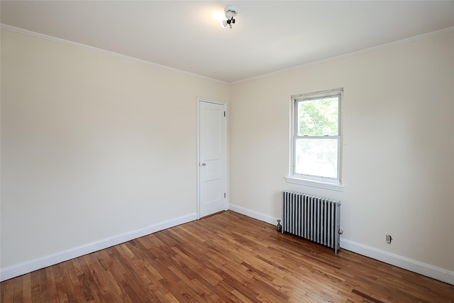 99 Roosevelt Ct, Carle Place, NY 11514 - empty room featuring radiator heating unit, wood finished floors, baseboards, and crown molding