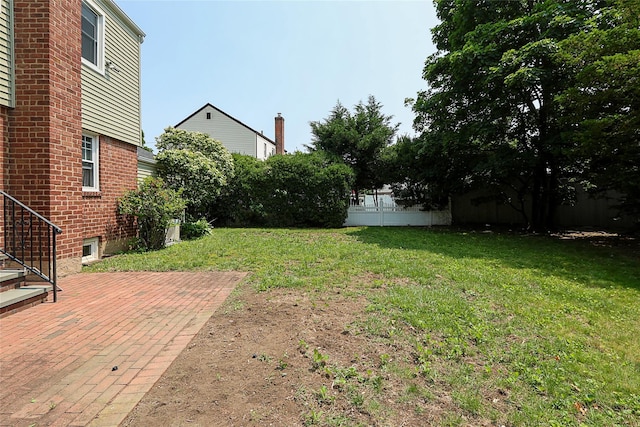 99 Roosevelt Ct, Carle Place, NY 11514 - view of green lawn with a patio