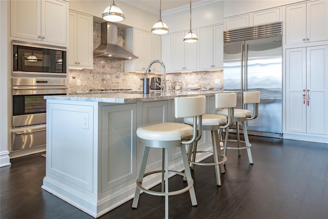 1000 Royal Ct Unit 1306, North Hills, NY 11040 - kitchen with wall chimney range hood, built in appliances, a warming drawer, crown molding, and backsplash