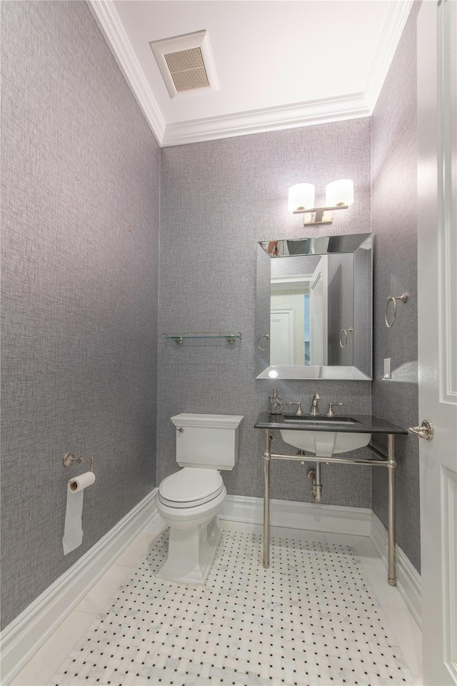 1000 Royal Ct Unit 1306, North Hills, NY 11040 - half bathroom featuring ornamental molding, toilet, tile patterned flooring, and baseboards