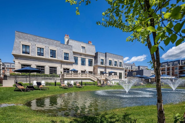 1000 Royal Ct Unit 1306, North Hills, NY 11040 - rear view of house with a water view, a high end roof, a yard, mansard roof, and a chimney