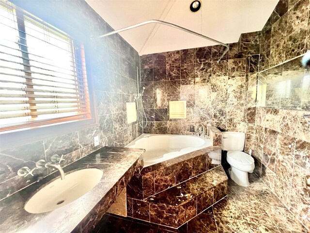 636 Derby Ave, Woodmere, NY 11598 - full bathroom featuring tile walls, a relaxing tiled tub, a sink, toilet, and healthy amount of natural light