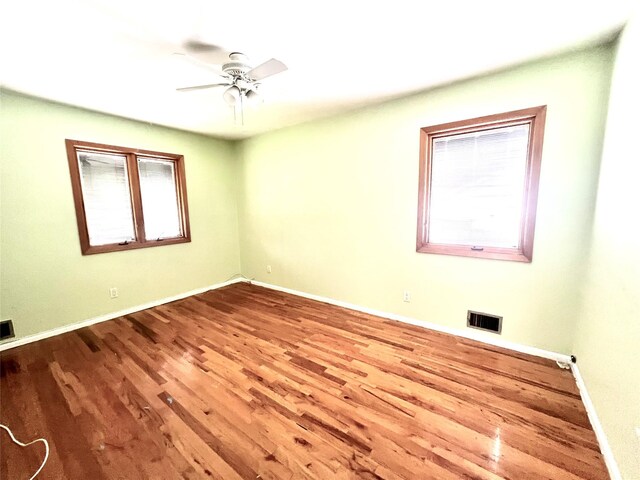 636 Derby Ave, Woodmere, NY 11598 - empty room featuring wood finished floors, healthy amount of natural light, ceiling fan, and baseboards