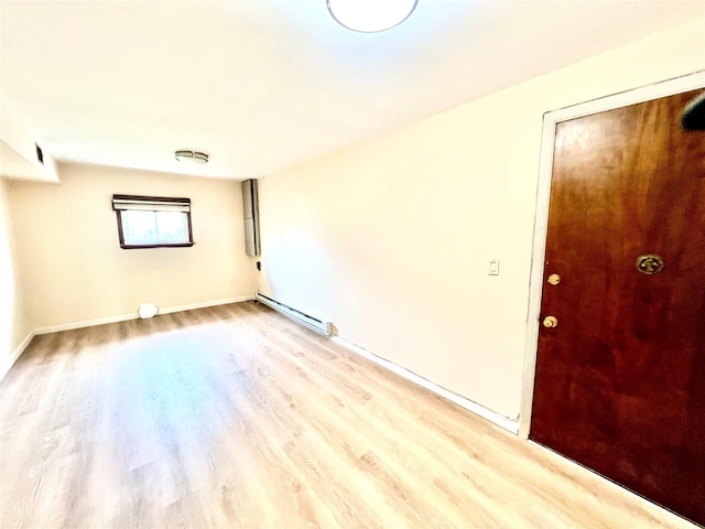 636 Derby Ave, Woodmere, NY 11598 - empty room featuring a baseboard heating unit, light wood-style flooring, and baseboards
