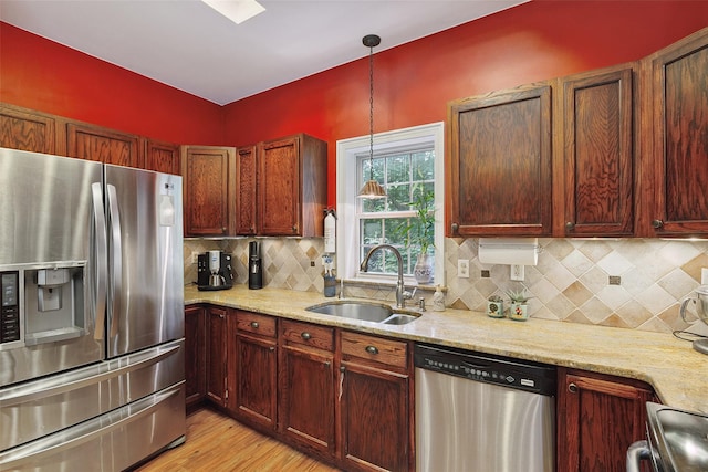 1771 Hanover St, Yorktown Heights, NY 10598 - kitchen with appliances with stainless steel finishes, light wood-style flooring, light stone counters, and backsplash