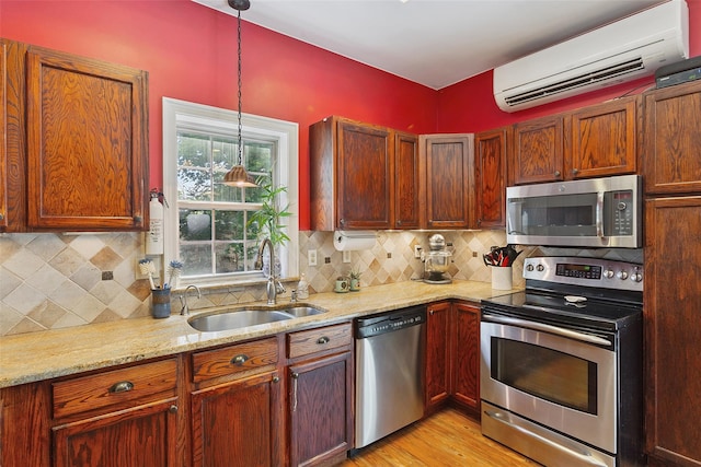 1771 Hanover St, Yorktown Heights, NY 10598 - kitchen featuring stainless steel appliances, a wall mounted air conditioner, light stone counters, decorative backsplash, and light wood-style flooring