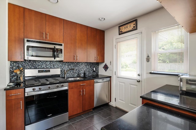 6 Plumtree Ln, South Huntington, NY 11746 - kitchen with appliances with stainless steel finishes, a sink, dark tile patterned flooring, backsplash, and brown cabinetry
