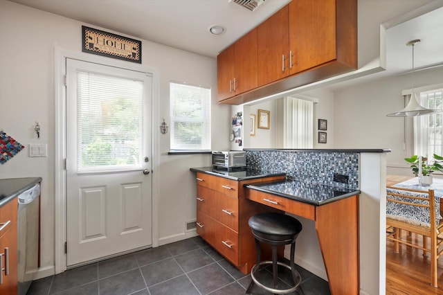 6 Plumtree Ln, South Huntington, NY 11746 - kitchen with brown cabinetry, dishwashing machine, dark countertops, and a peninsula