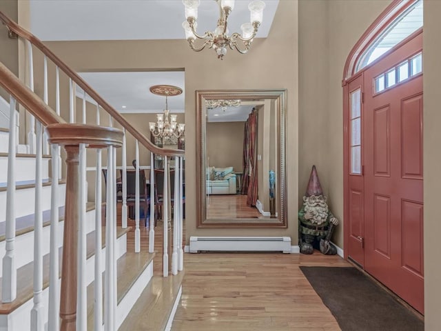 1674 Birch Dr, Merrick, NY 11566 - foyer featuring a chandelier, a baseboard heating unit, wood finished floors, stairway, and baseboards
