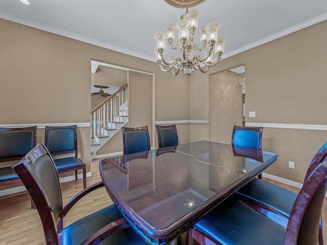 1674 Birch Dr, Merrick, NY 11566 - dining space with wood finished floors, a chandelier, stairs, baseboards, and crown molding