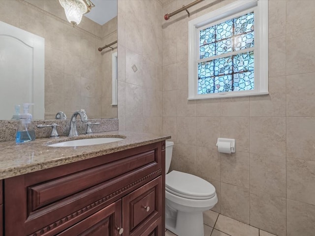 1674 Birch Dr, Merrick, NY 11566 - bathroom featuring tile walls, toilet, vanity, tile patterned flooring, and a shower