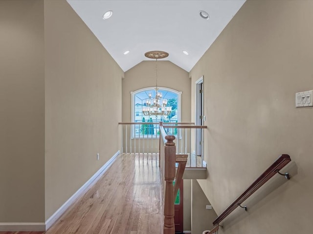 1674 Birch Dr, Merrick, NY 11566 - hall with an upstairs landing, a chandelier, baseboards, wood finished floors, and lofted ceiling