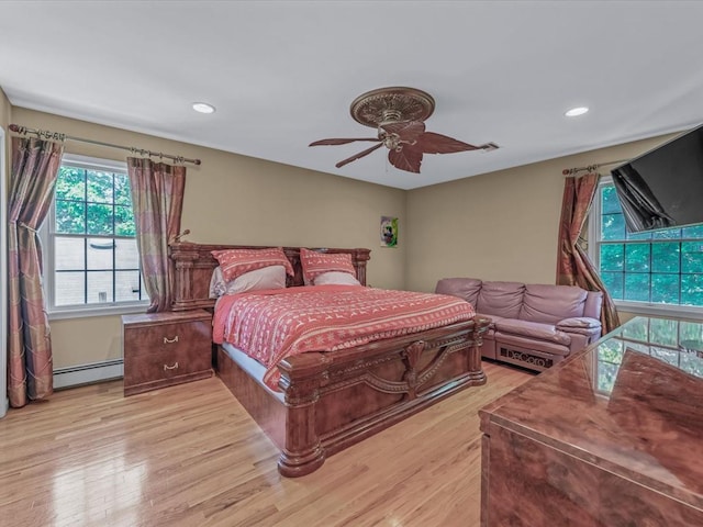1674 Birch Dr, Merrick, NY 11566 - bedroom featuring baseboard heating, light wood-type flooring, recessed lighting, and ceiling fan